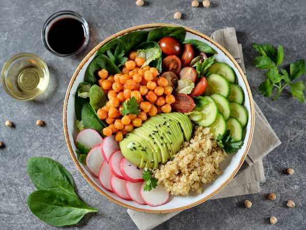 Deconstructed meal showing separate bowls of proteins, grains, and vegetables